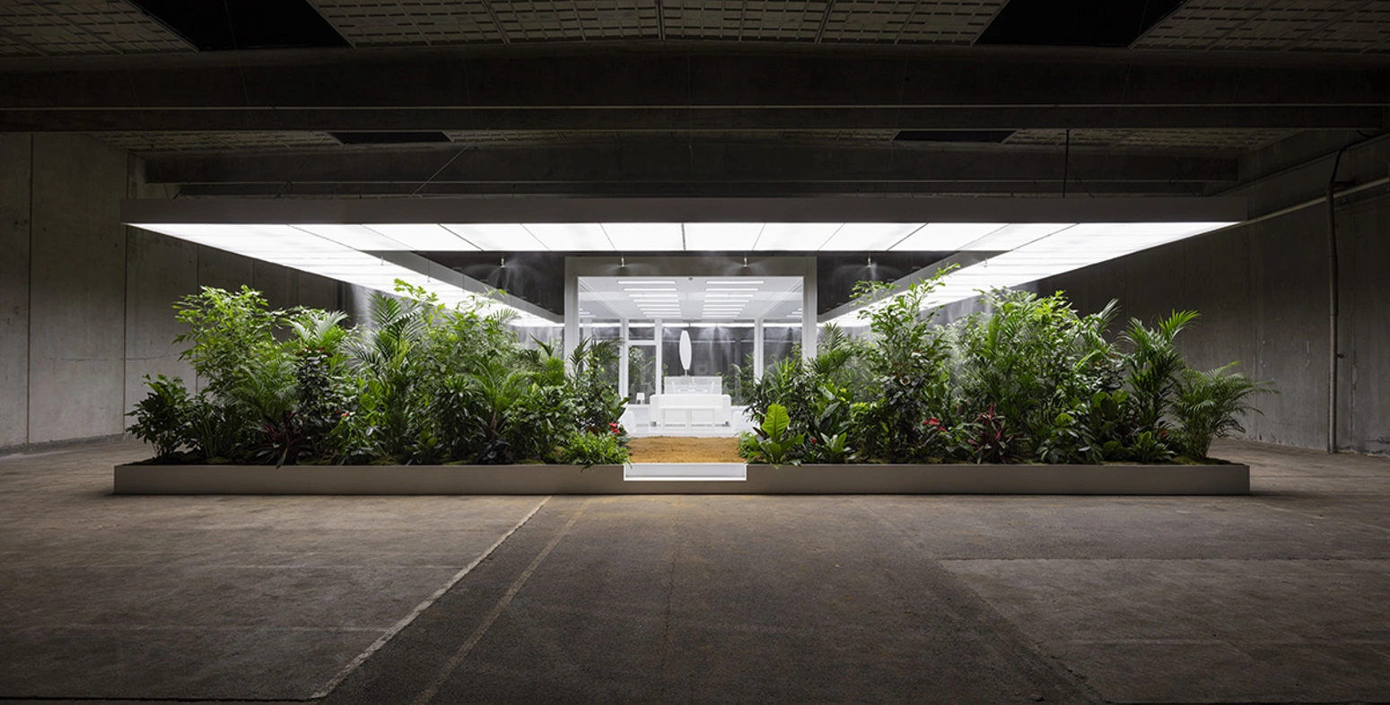 plants surrounding furniture in concrete gallry