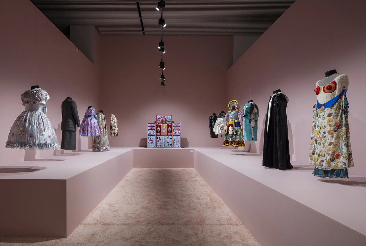 grayson perry costumes in pink room